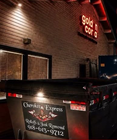 Cherokee Express dumpster on a commercial job at night